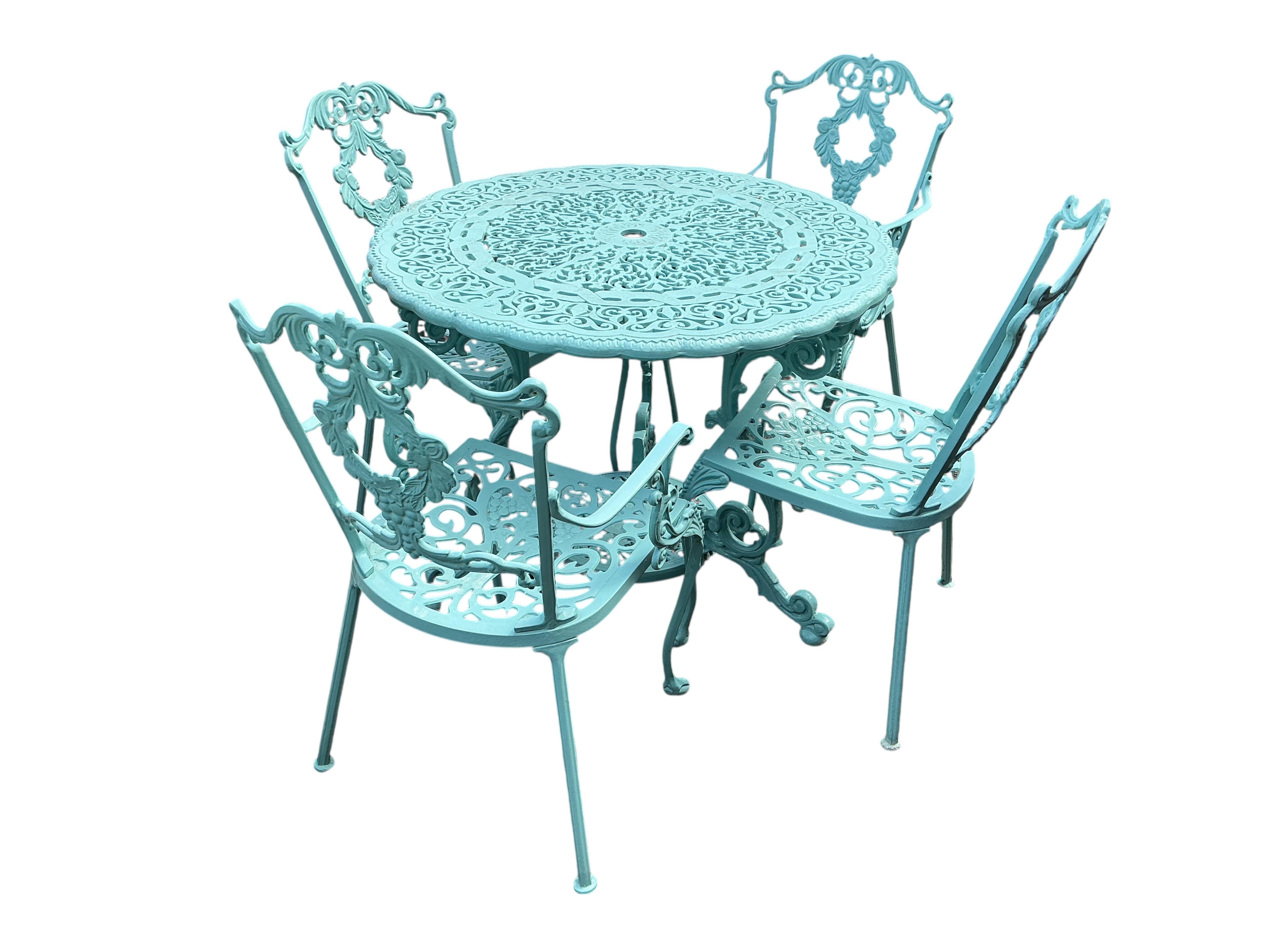 A painted circular aluminium garden table and four chairs, table diameter 92cm, height 71cm